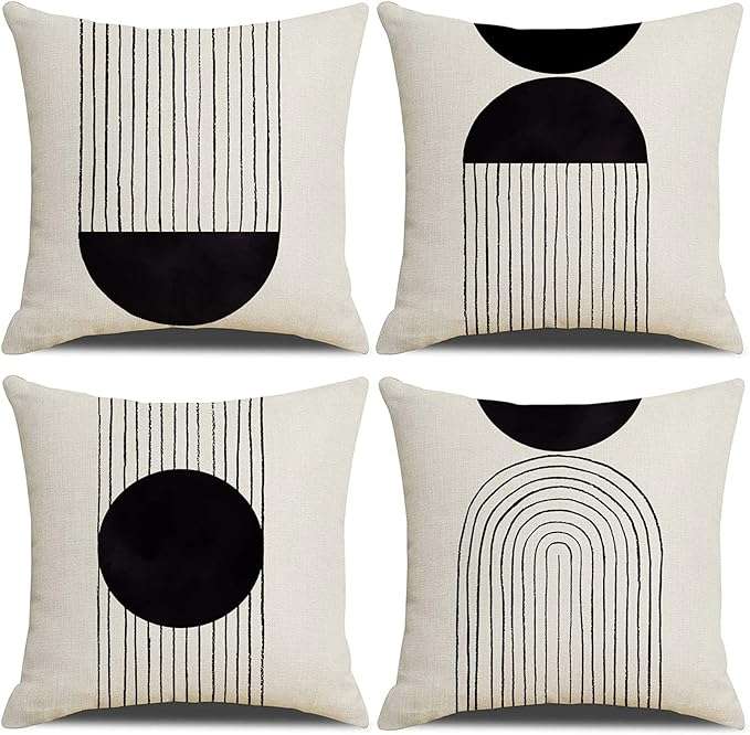 Mid century modern black and white tufted pillow cover with handwoven geometric design, adding texture and comfort to a cozy living room or bedroom setting.